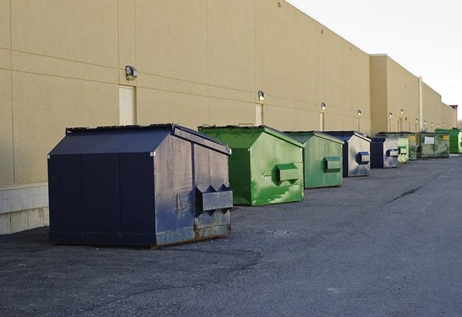 construction workers disposing of debris in large dumpsters in Morada CA