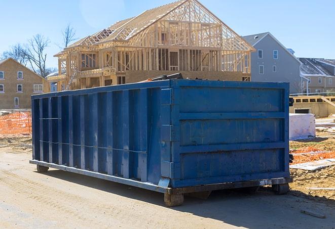 garbage dumpsters with lids at a residential site